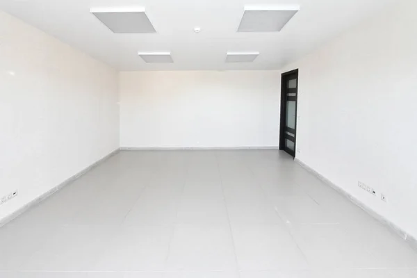 Yeni bir binada mobilyasız beyaz duvar kağıdı ile iç boş ofis ışık Oda
