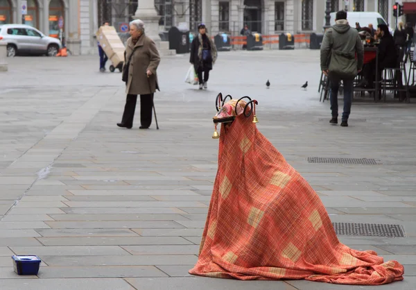 Street artist in the strange costume is entertaining passers Stock Image