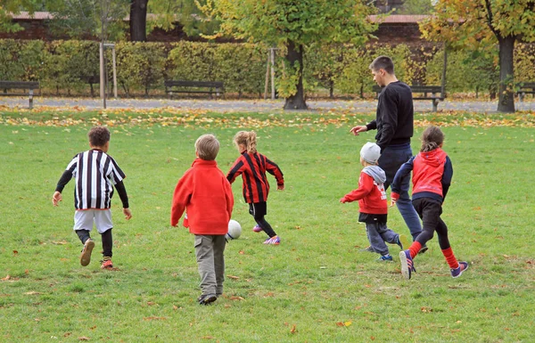 Children are playing football in city park — Stock Photo, Image