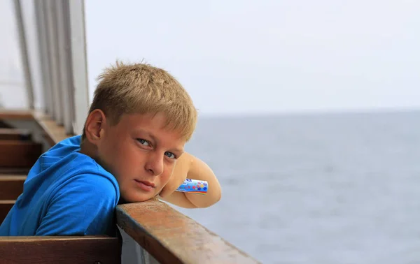 Boy is sitting on a seat in ferry — Stock Photo, Image