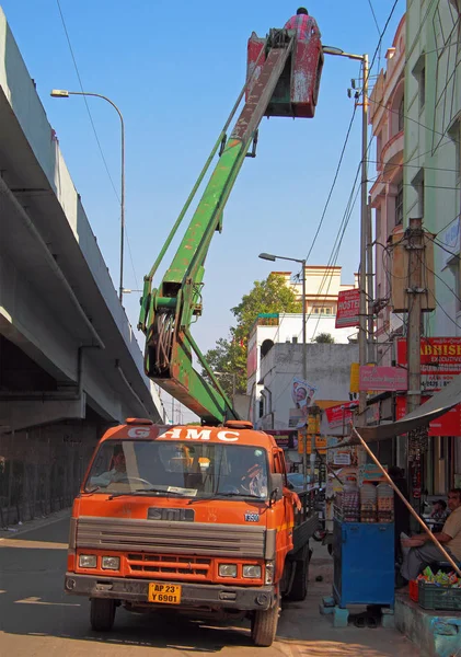 Hombre en la cubierta de elevación del manipulador está montando lámparas eléctricas — Foto de Stock