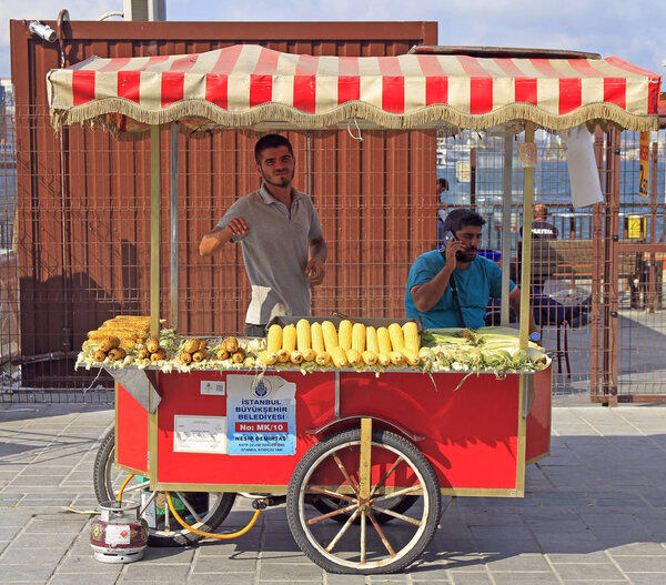 man is selling fried corn and chestnut outdoor in Istanbul