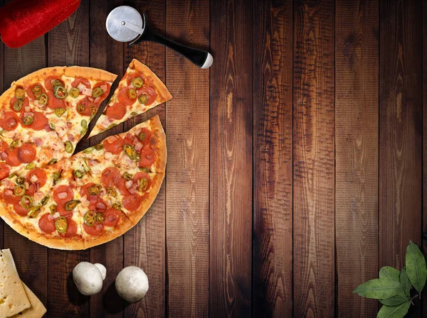 Pizza fresca con funghi salame pepe su becco scuro — Foto Stock