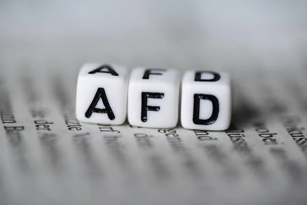 Word AFD formed by wood alphabet blocks on newspaper german party politics — Stock Photo, Image