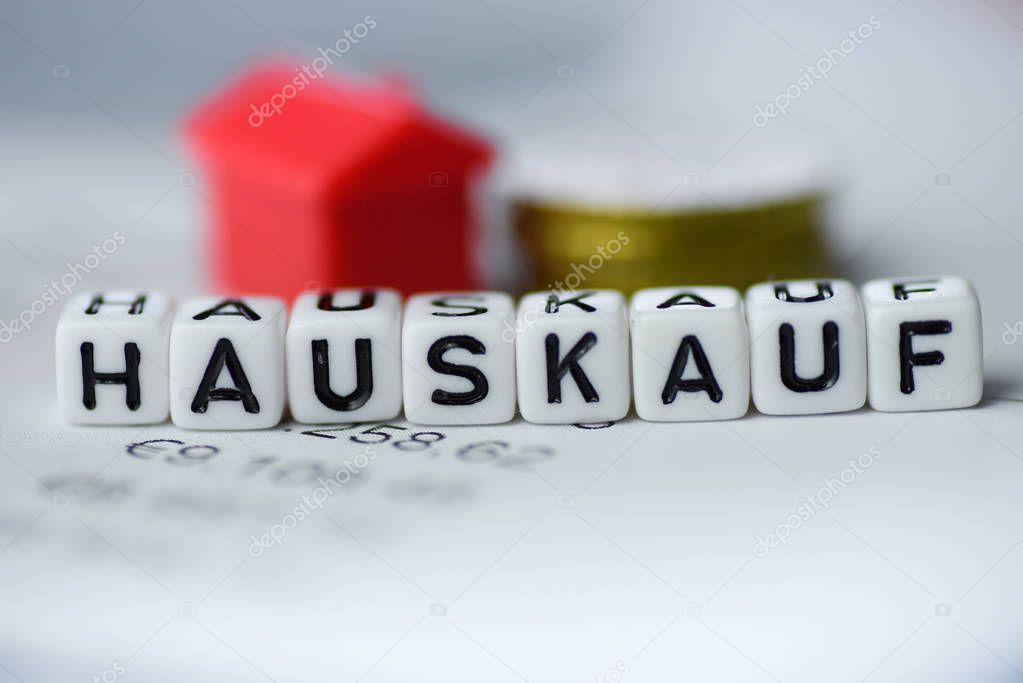 German Word HOUSE PURCHASE formed by alphabet blocks: HAUSKAUF