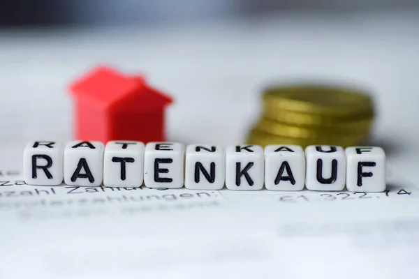 German Word HIRE PURCHASE formed by alphabet blocks: RATENKAUF