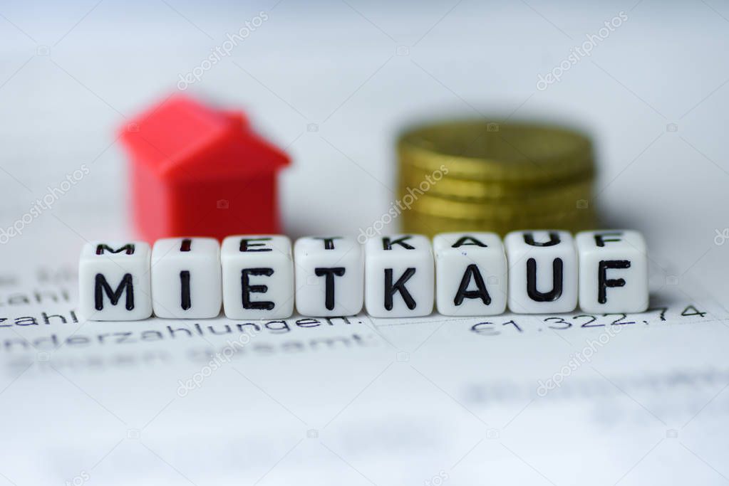 German Word RENT PURCHASE formed by alphabet blocks: MIETKAUF