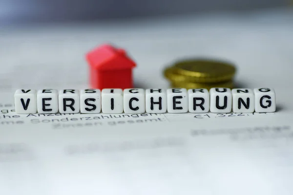 German Word INSURANCE formed by alphabet blocks: VERSICHERUNG