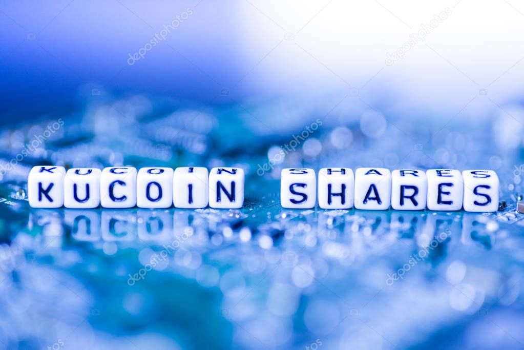 Word KUCOIN SHARES formed by alphabet blocks on mother cryptocurrency