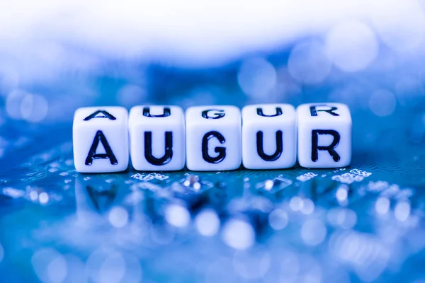 Word AUGUR formed by alphabet blocks on mother cryptocurrency — Stock Photo, Image