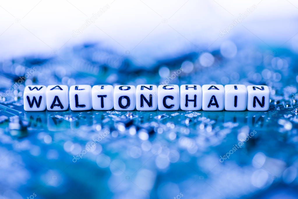 Word WALTONCHAIN formed by alphabet blocks on mother cryptocurrency