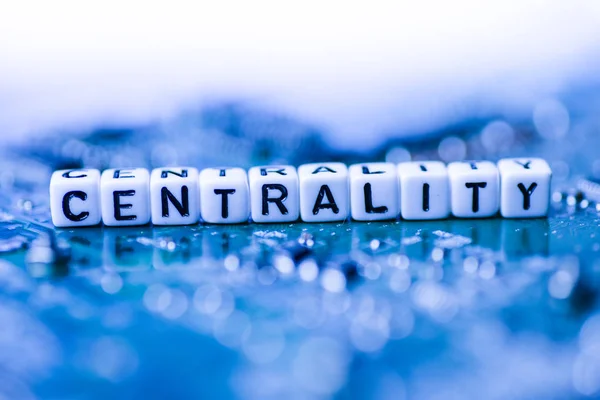 Word CENTRALITY formed by alphabet blocks on mother cryptocurrency — Stock Photo, Image