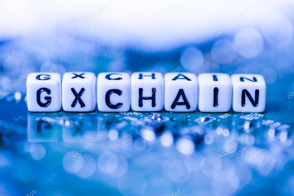 Word GXCHAIN formed by alphabet blocks on mother cryptocurrency