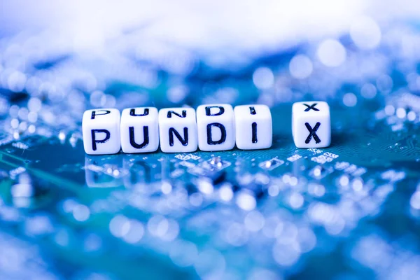 Word PUNDI X formed by alphabet blocks on mother cryptocurrency — Stock Photo, Image