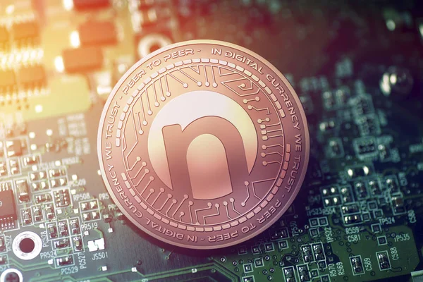 Shiny copper NAMETOKEN cryptocurrency coin on blurry motherboard background — Stock Photo, Image