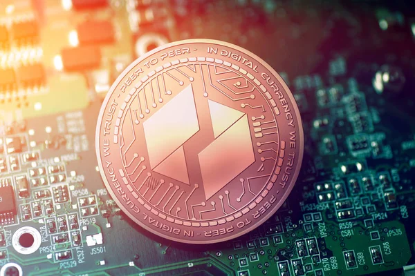 Shiny copper UBIQ cryptocurrency coin on blurry motherboard background — Stock Photo, Image