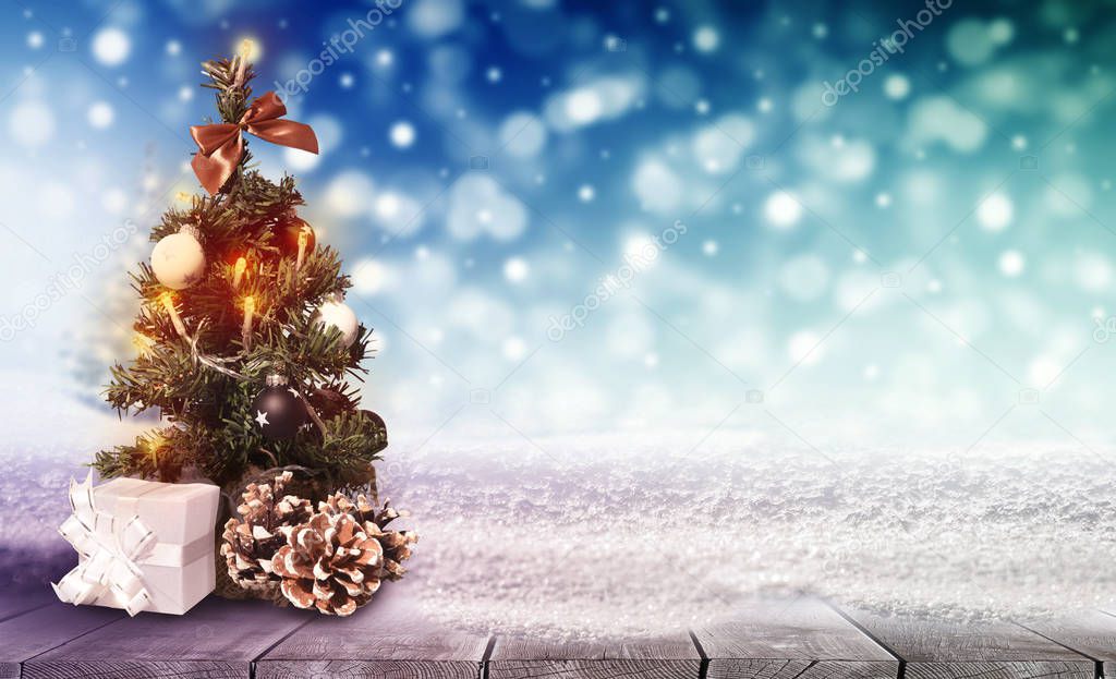 Beautiful decoration christmas tree on table with snow on blurred colorful bokeh background