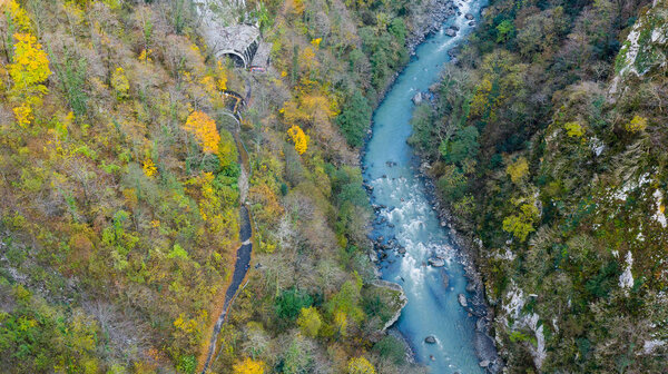 Aerial view from above. Mountain river in the forest. Green tree.