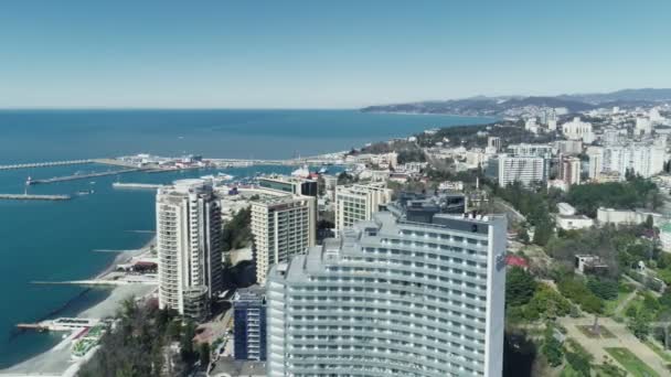 Sochi. Russia - 03.03.2020 Panorama on the center of the city resort of Sochi. Aerial video. The Black Sea. View from above. Hotel and resort. Apartments by the sea. Its a clear sunny day. — Stock Video