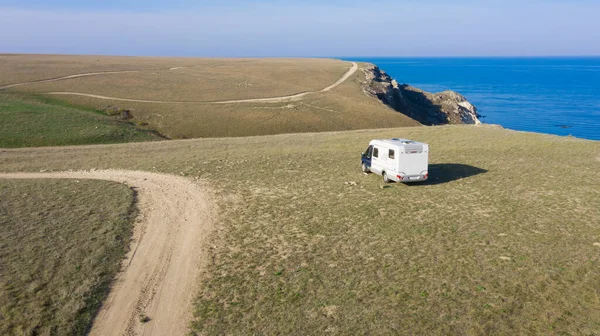 A motor home by the sea. Aerial photography. From a bird\'s-eye view. A house on wheels. Self-isolation. Life in nature. Camper. RV