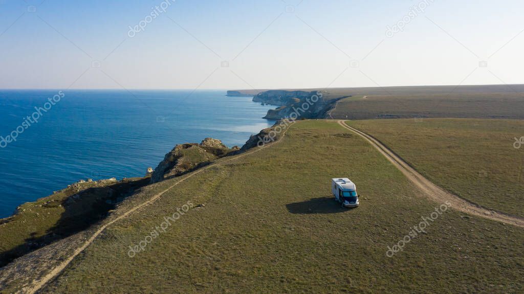 A motor home by the sea. Aerial photography. From a bird's-eye view. A house on wheels. Self-isolation. Life in nature. Camper. RV