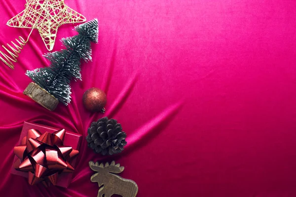 Presente de xmas com decoração e cone de pinho em tecido vermelho — Fotografia de Stock