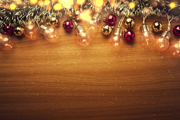 Xmas light party bulb with fir on wood background — Stock Photo, Image