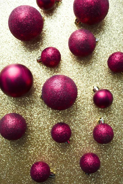 Red glitter ball decor on gold background — Stock Photo, Image