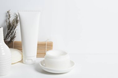 Güzellik tedavisi medikal cilt bakımı ve kozmetik krem serumu. Beyaz dekor arka planı, sağlık ve tıp konsepti üzerine yağ taklit şişesi ambalajlama ürünü.