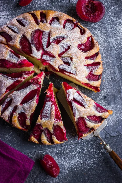 Rustic plum  cake on dark background — Stock Photo, Image