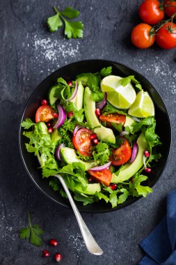 avocado, tomato and arugula salad. Healthy vegan food.  clipart