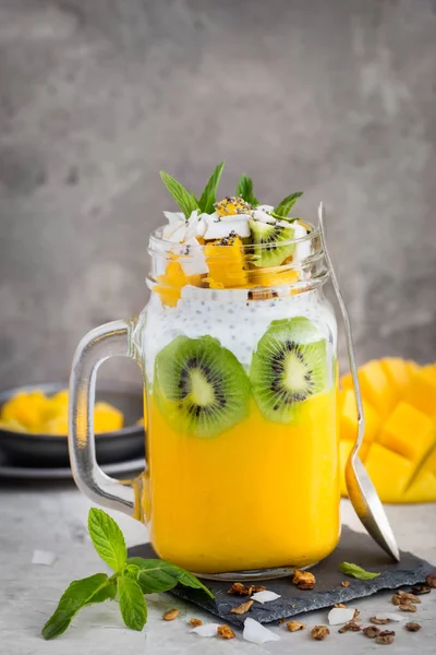 Mango,  coconut and chia seeds pudding in glass jar — Stock Photo, Image
