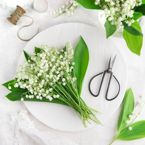 Lily of the valley flowers on white wooden tray — Stock Photo, Image