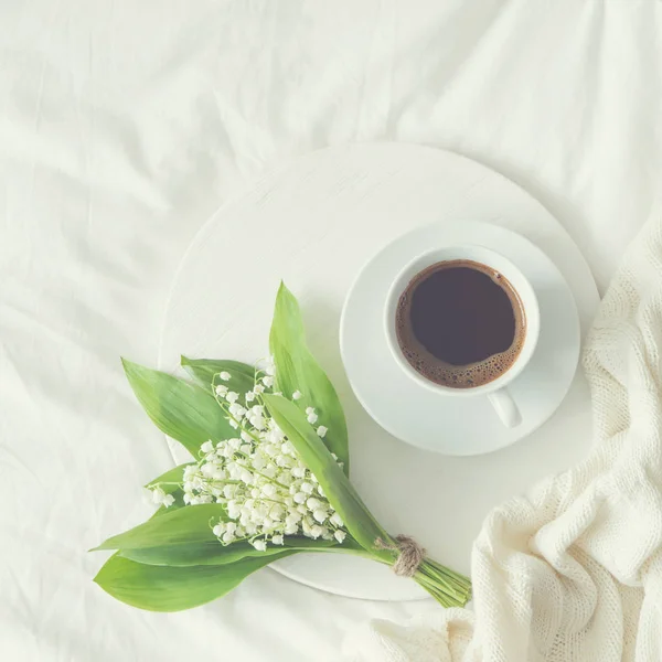 Desayuno en la cama. taza de café y lirio del valle — Foto de Stock