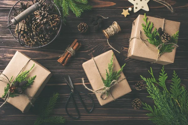 Christmas or New Year gifts wrapped in kraft paper — Stock Photo, Image