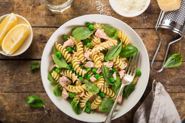 Fusilli pasta met zalm, spinazie en groene erwten — Stockfoto