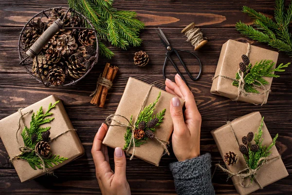 Woman packs  Christmas or New Year gift — Stock Photo, Image