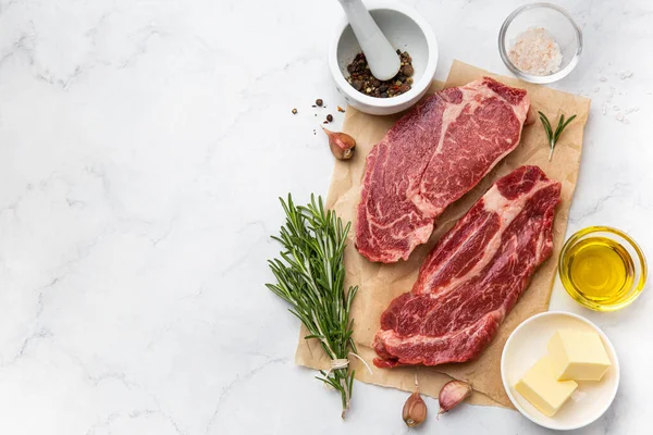 Fresh raw beef steaks with ingredients — Stock Photo, Image