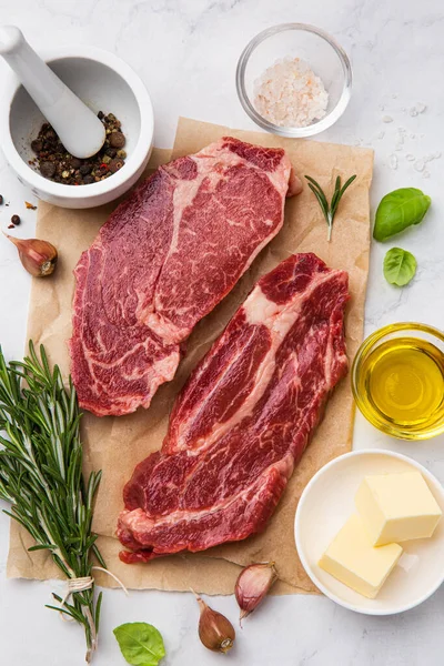 Fresh raw beef steaks with ingredients — Stock Photo, Image
