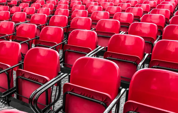 Empty plastic red chairs In outdoor theater