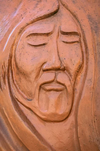 Relief sculpture of Jesus\' face, made out of modelling clay. Ideal for concepts, events or backgrounds.