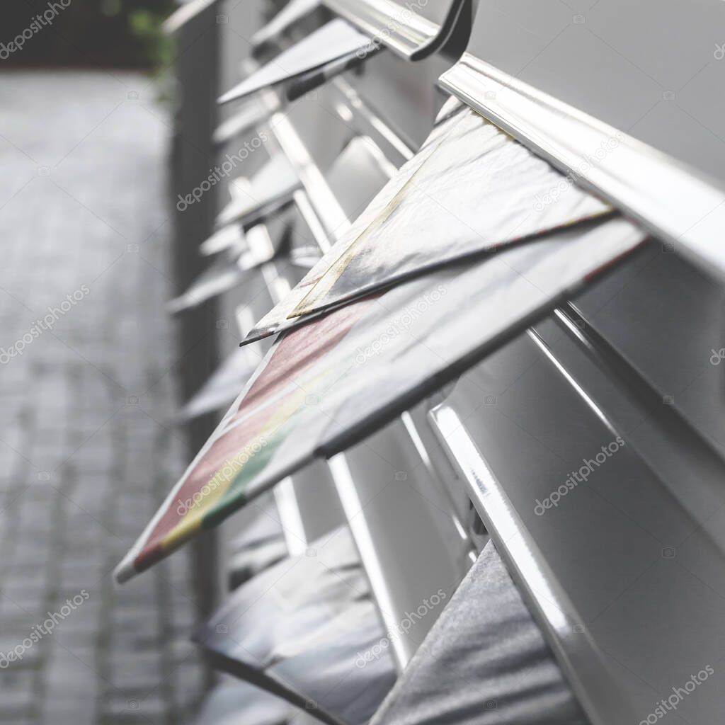 Filled letterboxes. Modern mailboxes filled of leaflets. Business and advertising concepts. Shallow depth of field.