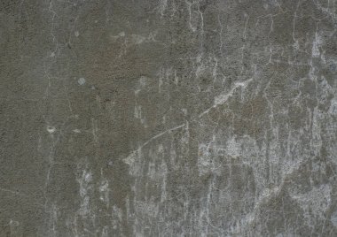 Karanlık beton duvar yüzeyinde küçük çatlaklar ile