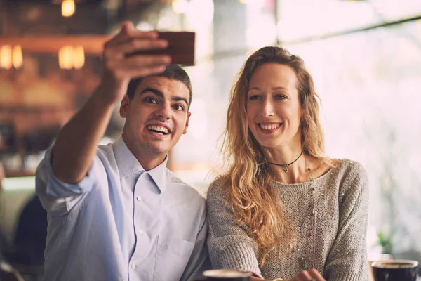 Man with woman making selfie in cafe — Stock Photo, Image
