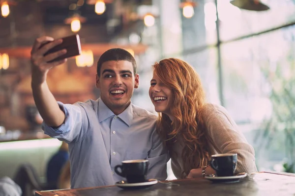 Bărbat cu femeie care face selfie în cafenea — Fotografie, imagine de stoc