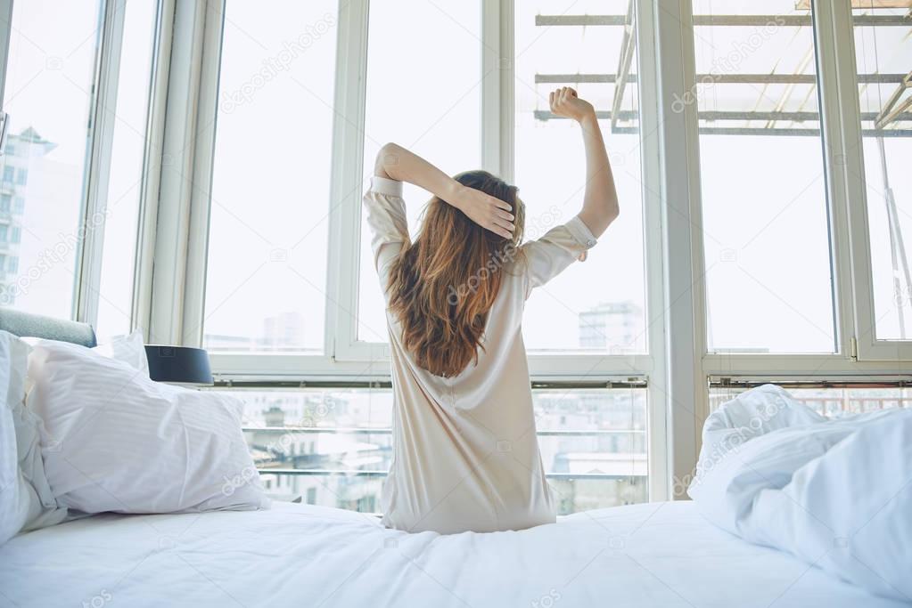 Woman sitting on bed 