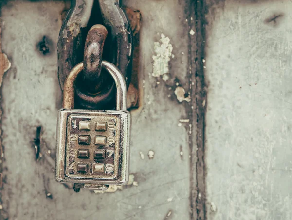 Old Padlock with key code on Wooden Gate