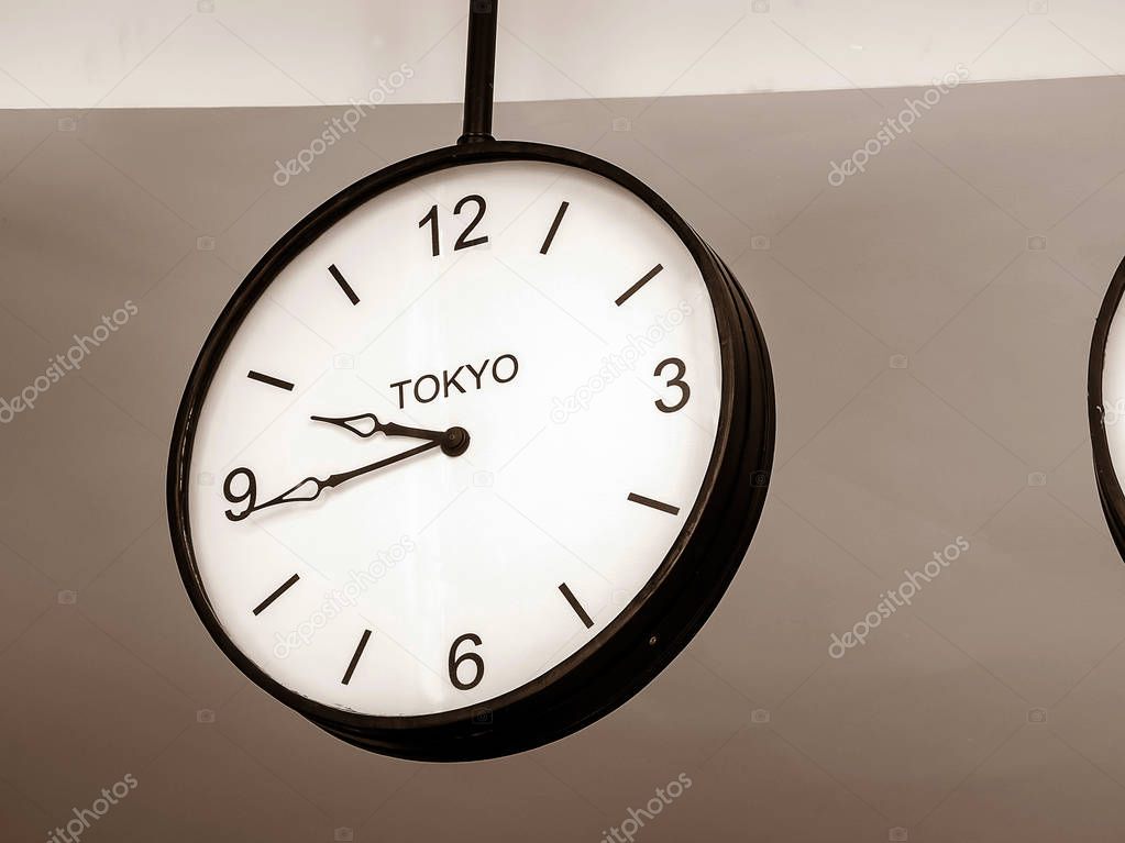 An airport clock showing Tokyo time zone