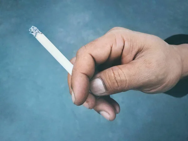 Cigarette burns on dirty hand — Stock Photo, Image