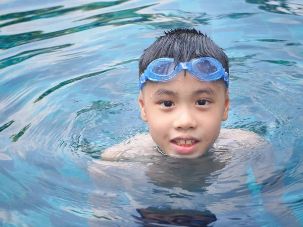 Asia boy kid child nine years old in swimming pool